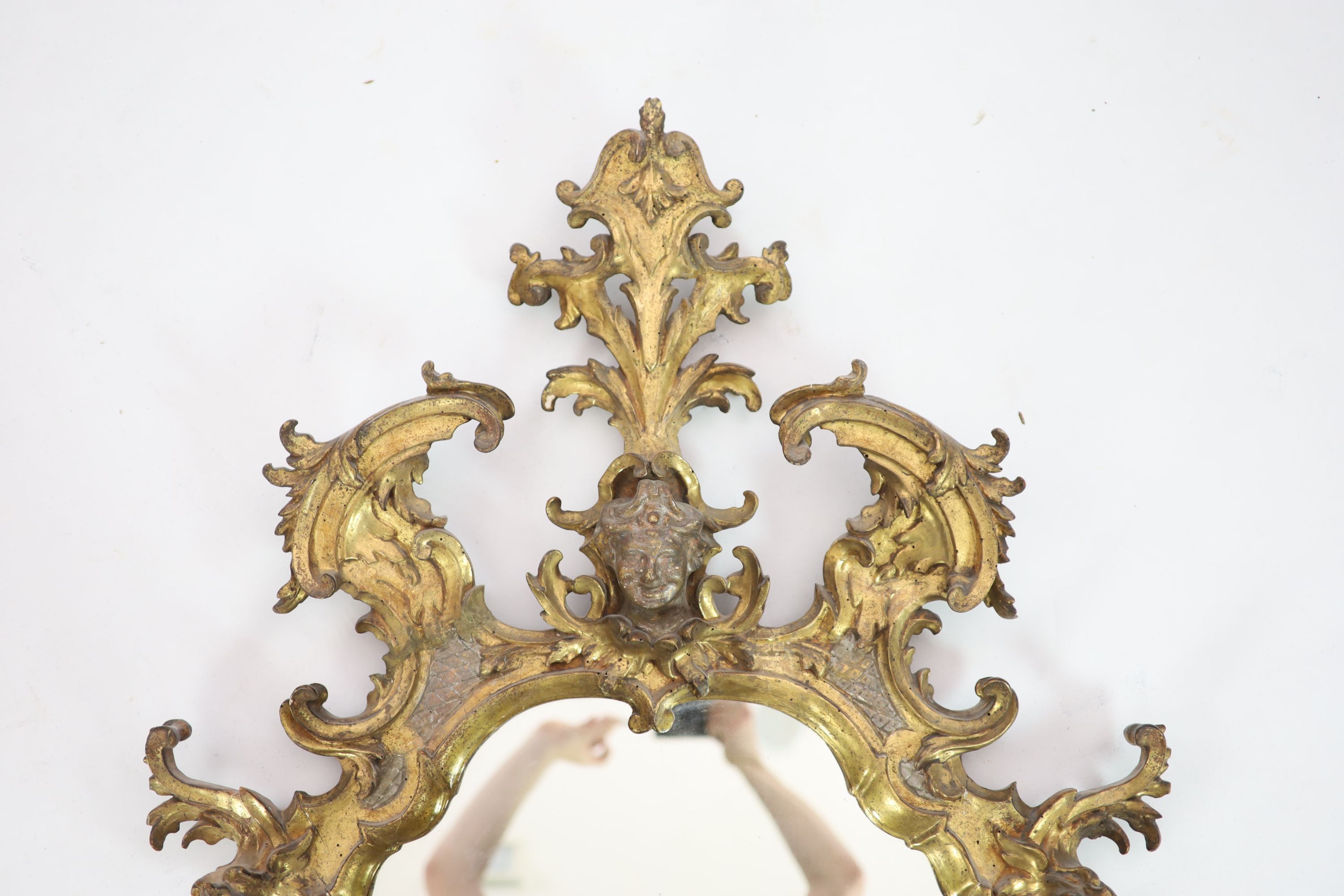 An 18th century Florentine giltwood wall mirror, W.78cm H.140cm